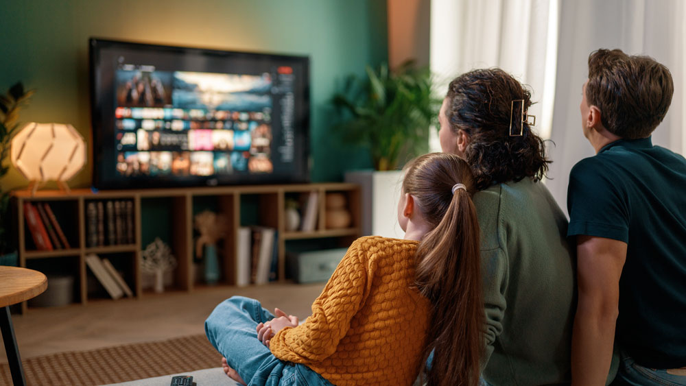 family watching tv on couch