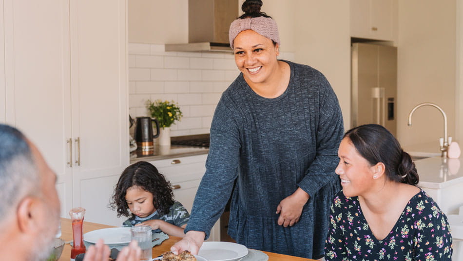 family enjoying dinner up the kitchen table