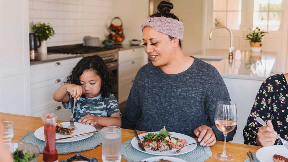Mother and daughter eating dinner