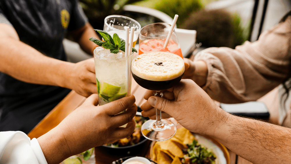 Friends cheersing over dinner.